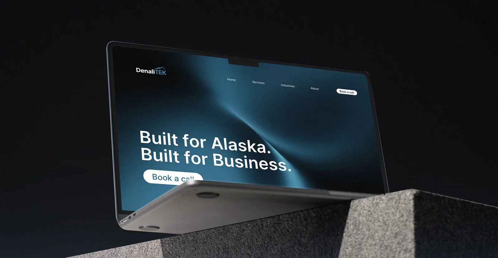DenaliTEK website shown on a laptop mockup designed by SparkStory